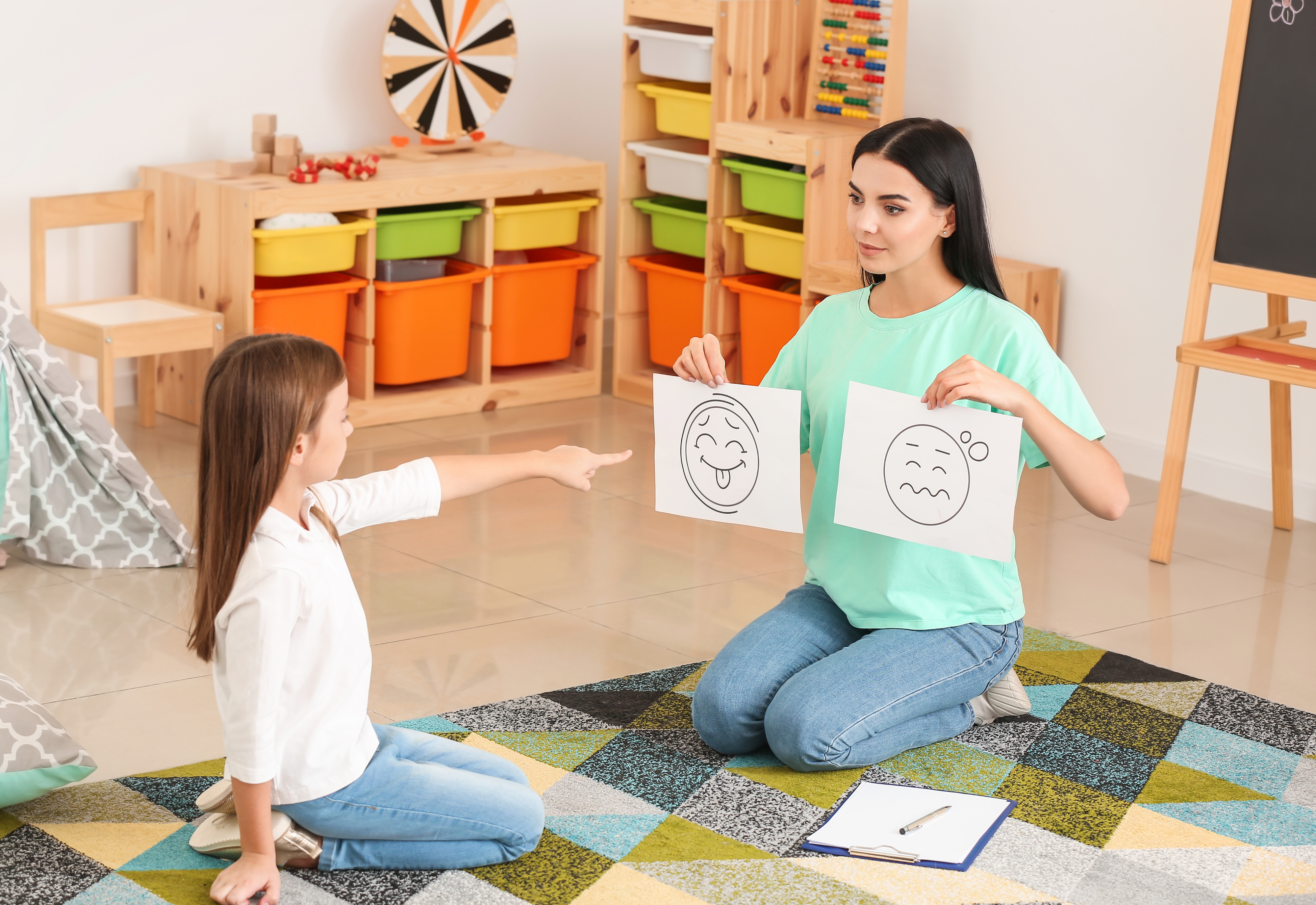 An educational psychologist working with a child on their emotional development, demonstrating non-teaching jobs in schools. 